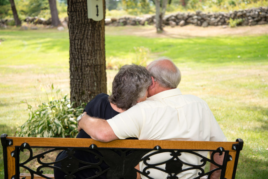 couple sitting on a bench snuggling