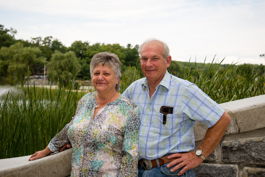 Sixty Years of marriage standing on a bridge in front of pond
