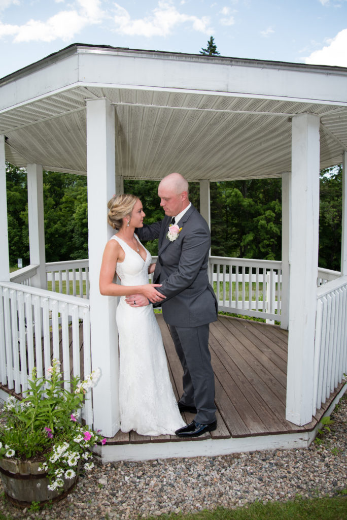 Bride and groom in the gazebo facing each other 