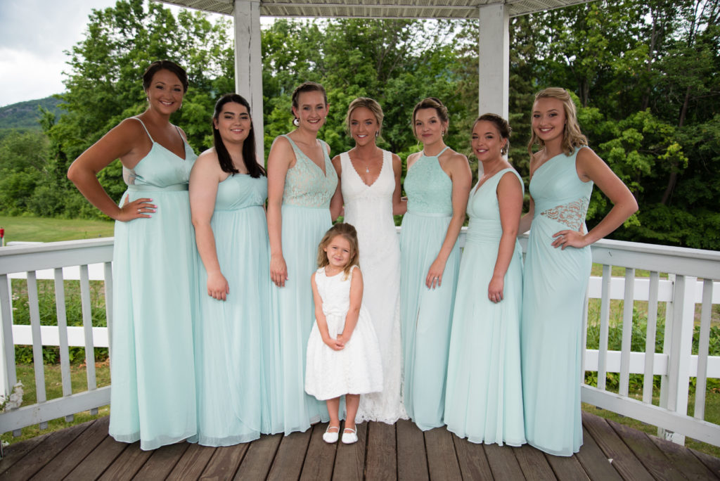 Bride with her bridesmaids and flower girl in the gazebo