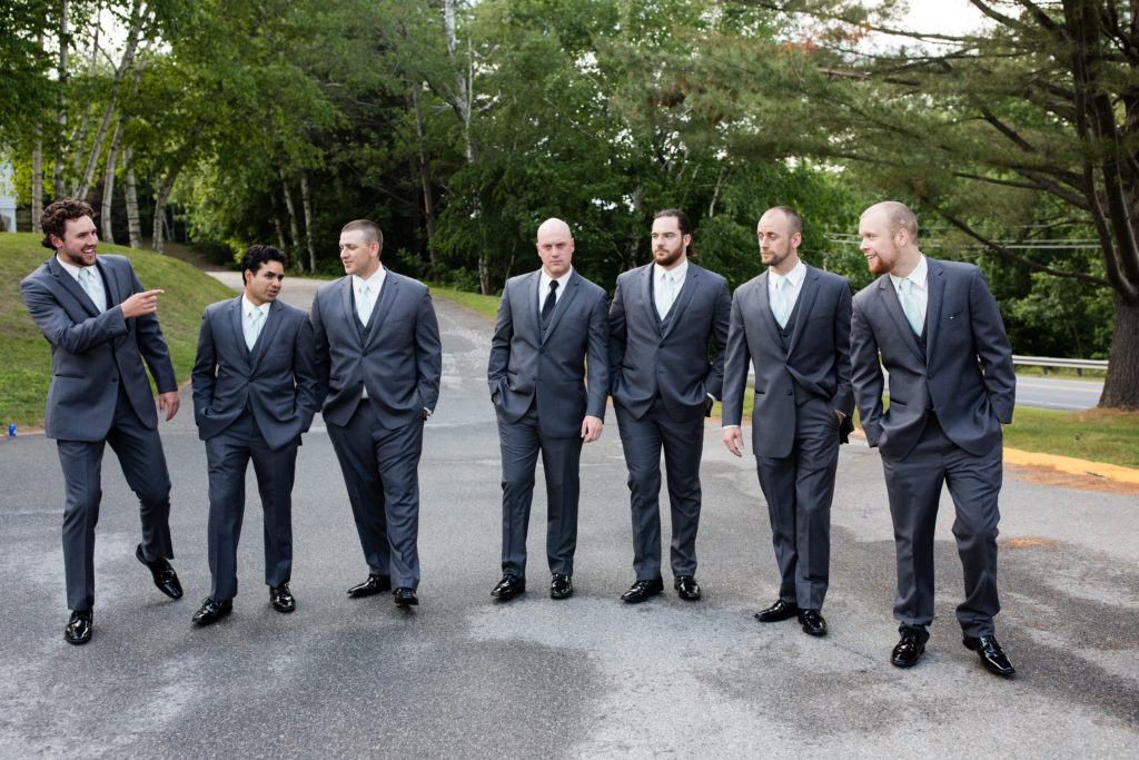 groom and groomsmen walking and looking at each other