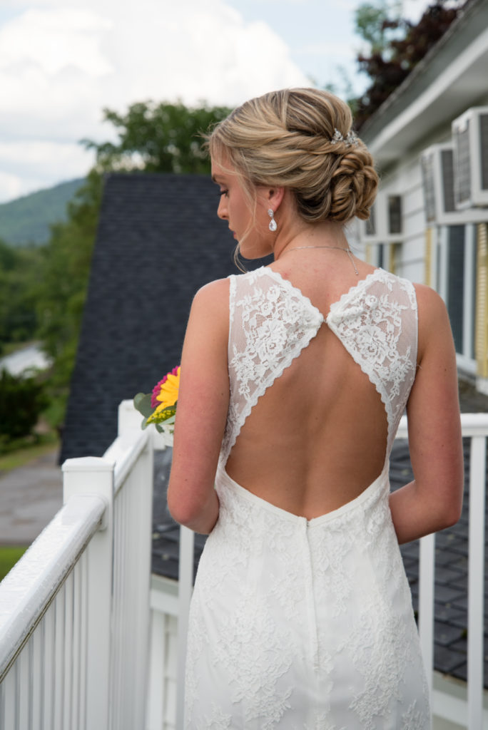Bride out on the balcony facing away - open back dress