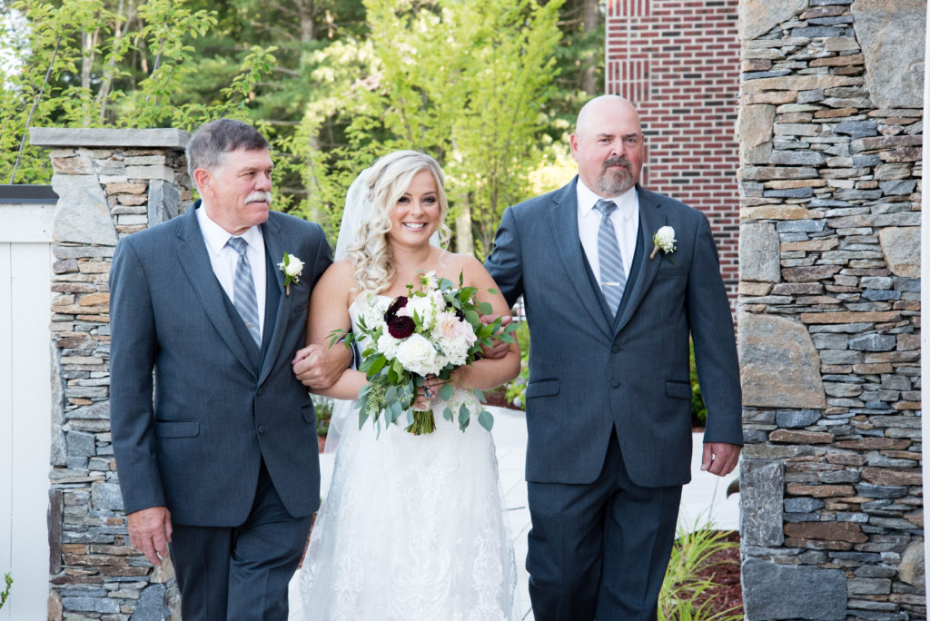 Bride with her two dads about to walk down the aisle