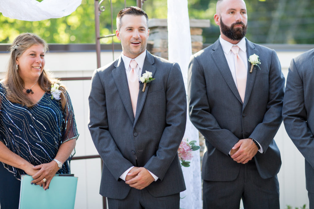 groom's expression to bride walking down the aisle