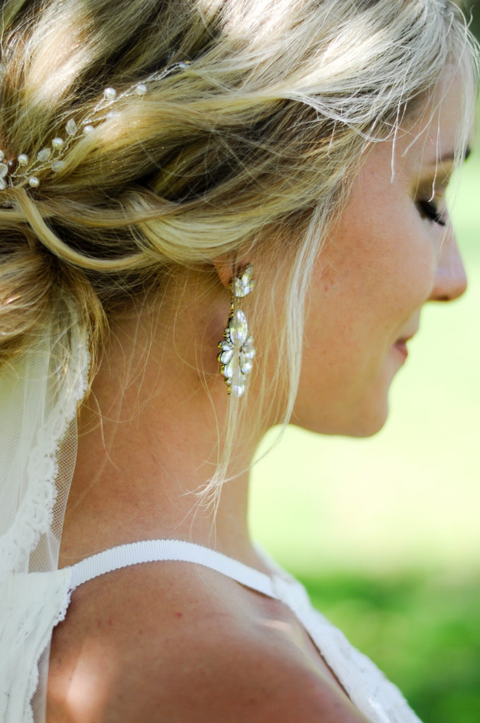 close up on details on bride's jewelry and hair