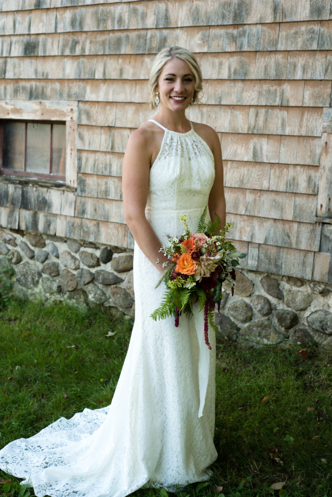 bridal portrait with bouquet in front of barn