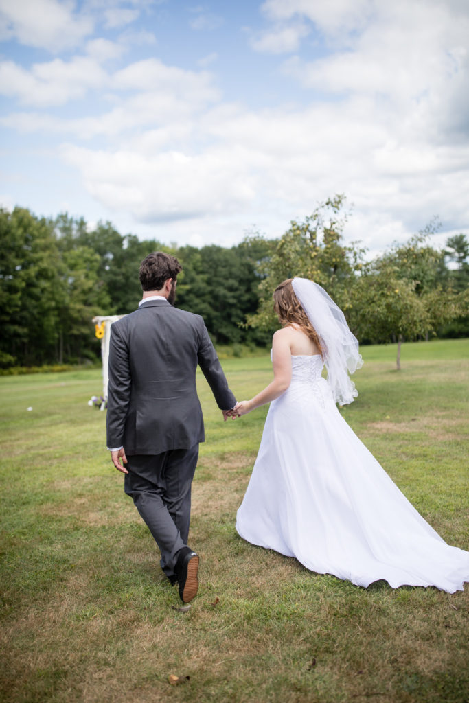 bride and groom walking away 