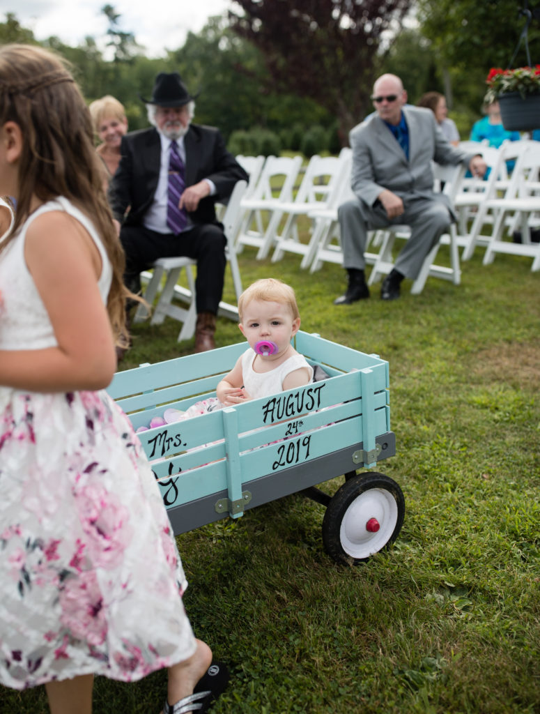 flower girl being pulled in the wagon