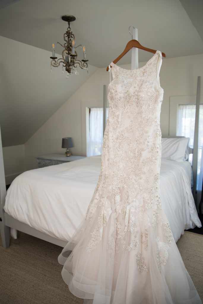Bride's dress hanging on the bed