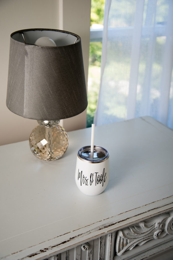 Mrs cup on the dresser with lamp and window