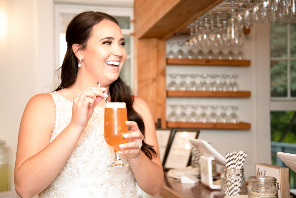 Bride drinking a beer with a straw