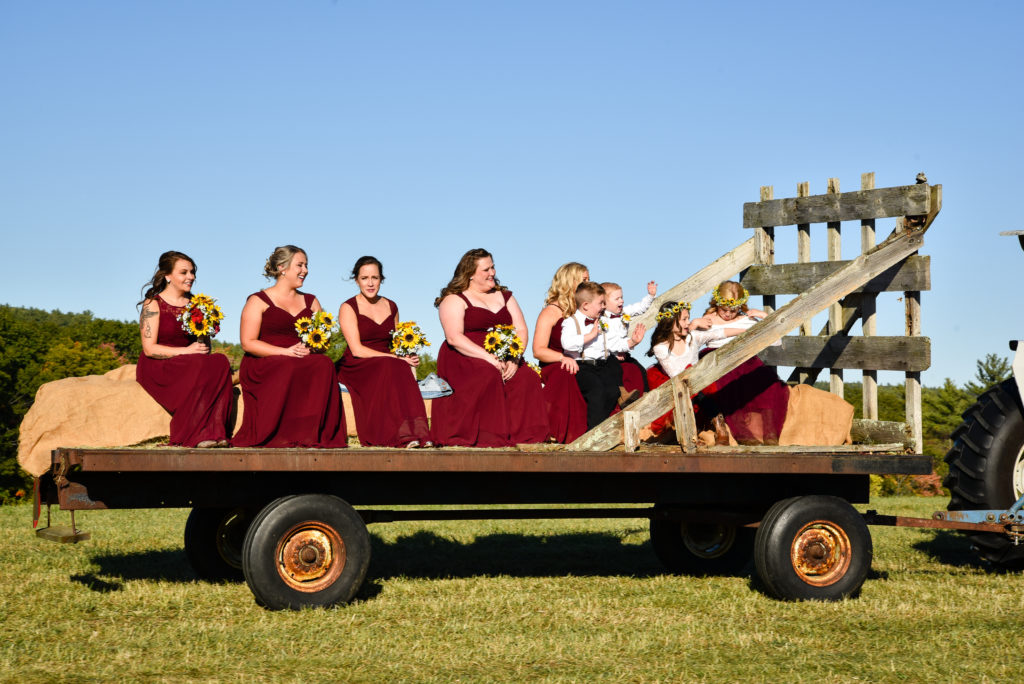 bridesmaids arriving on hay wagon