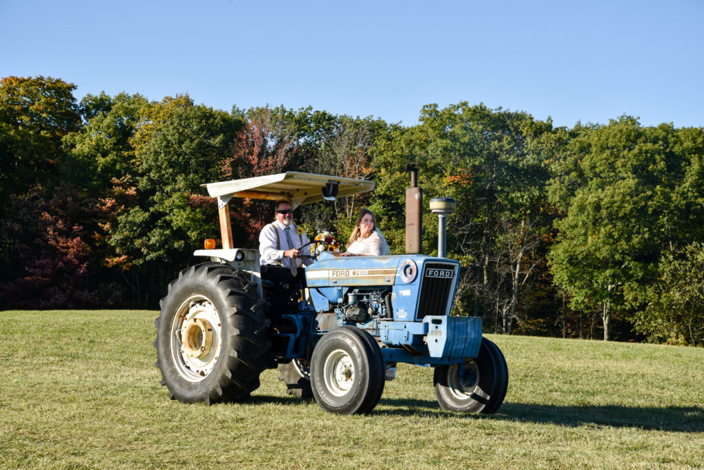 father and daughter arriving on tractor 