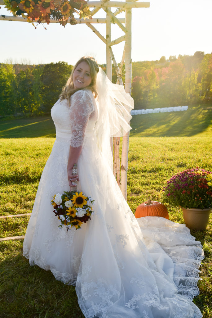 bridal portrait in a hay field at golden hour