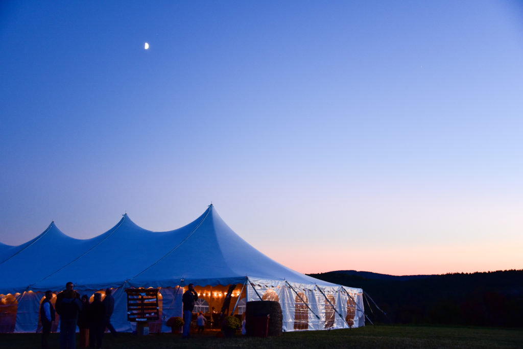 wedding tent with moon above at sunset