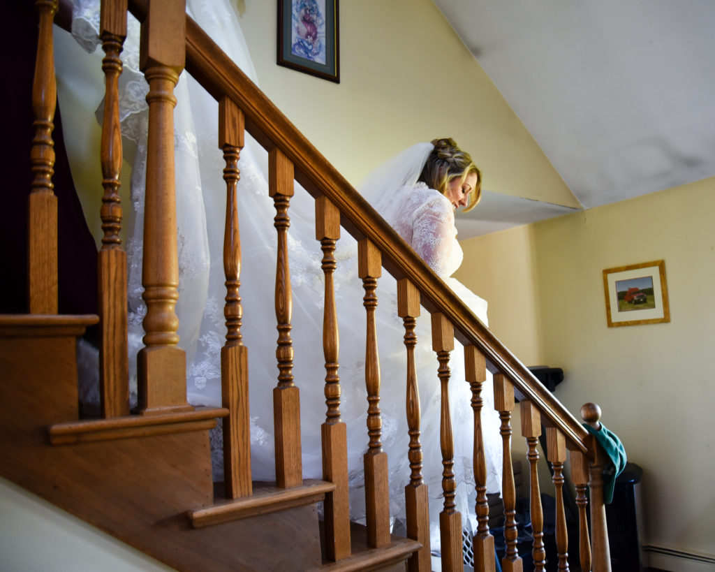bride walking down the stairs in her dress