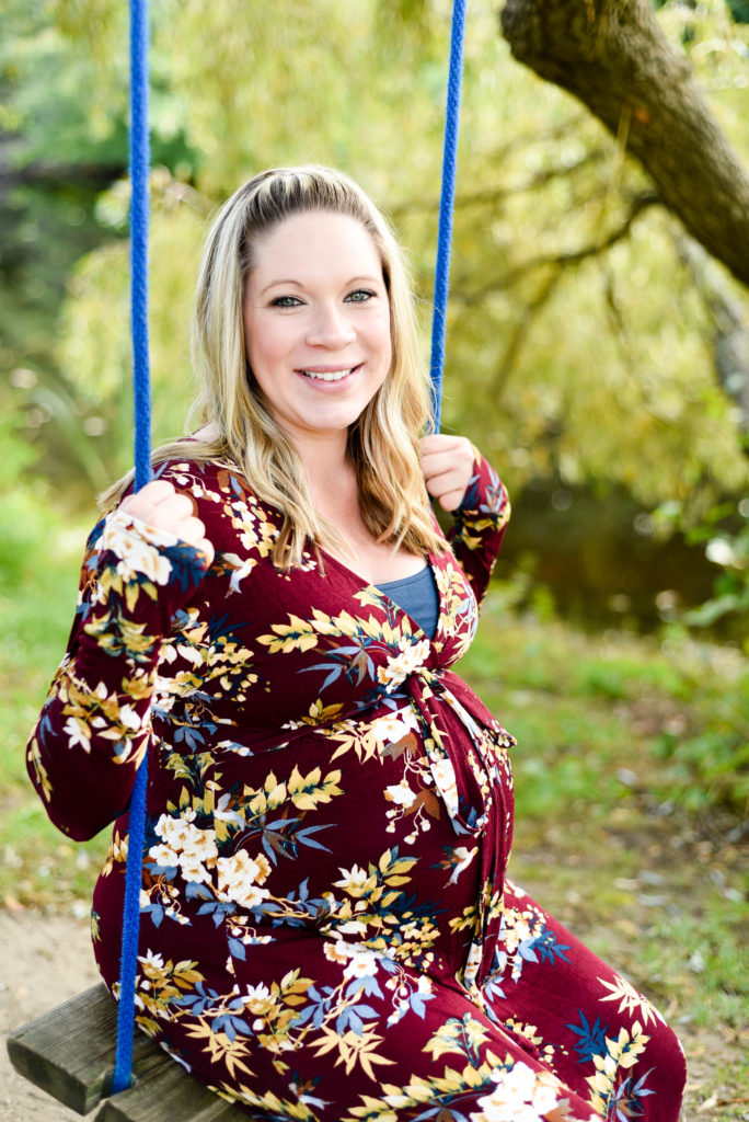 mom to be sitting on swing
