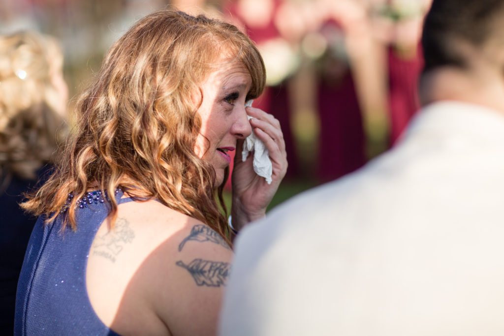 mother of bride tearing up at ceremony