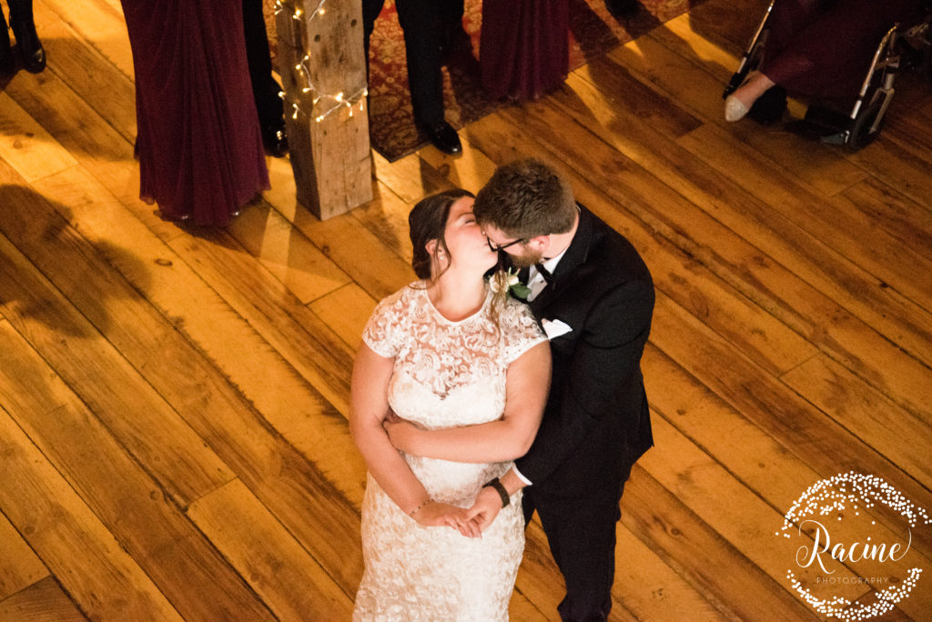 Bride and groom kissing after first dance