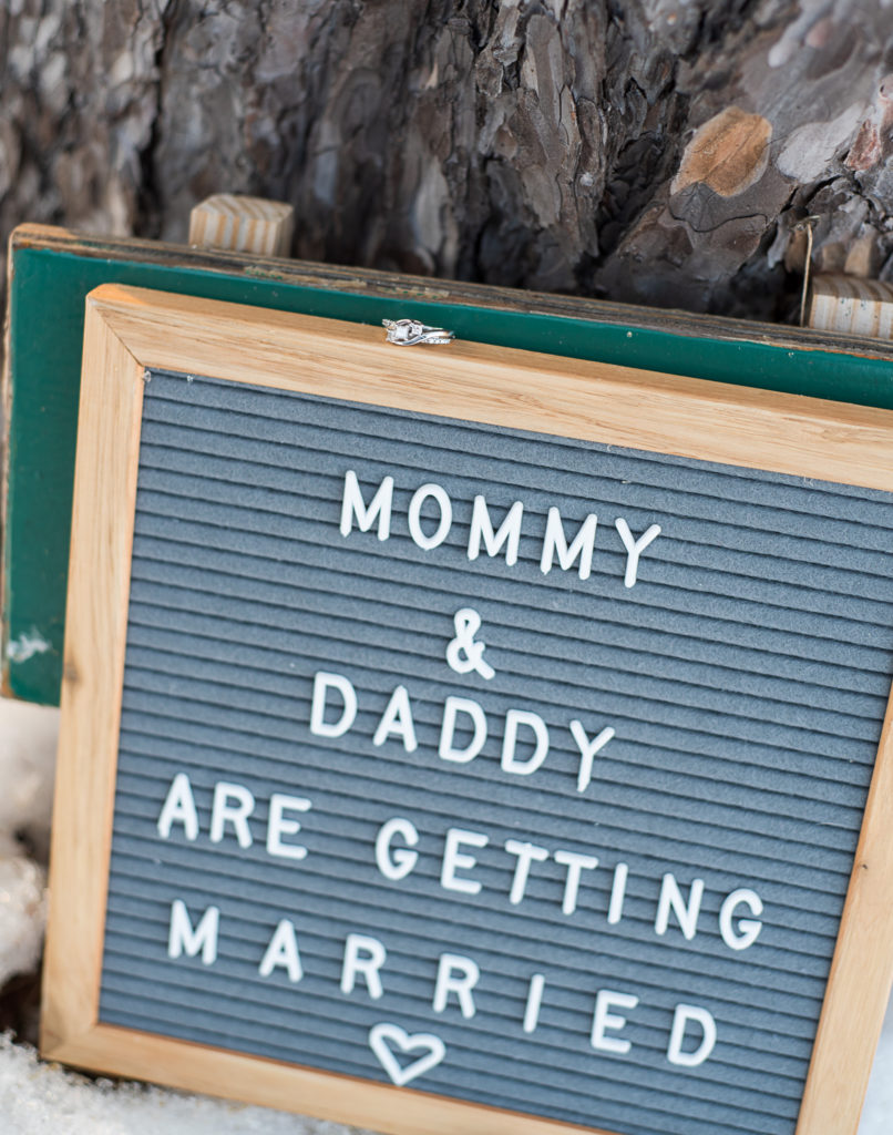 engagement ring on top of "Mommy and Daddy are getting married" sign