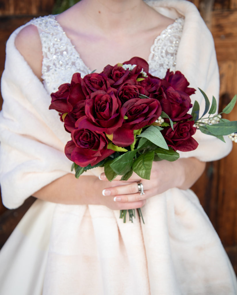 close up of bride's dress and bouquet