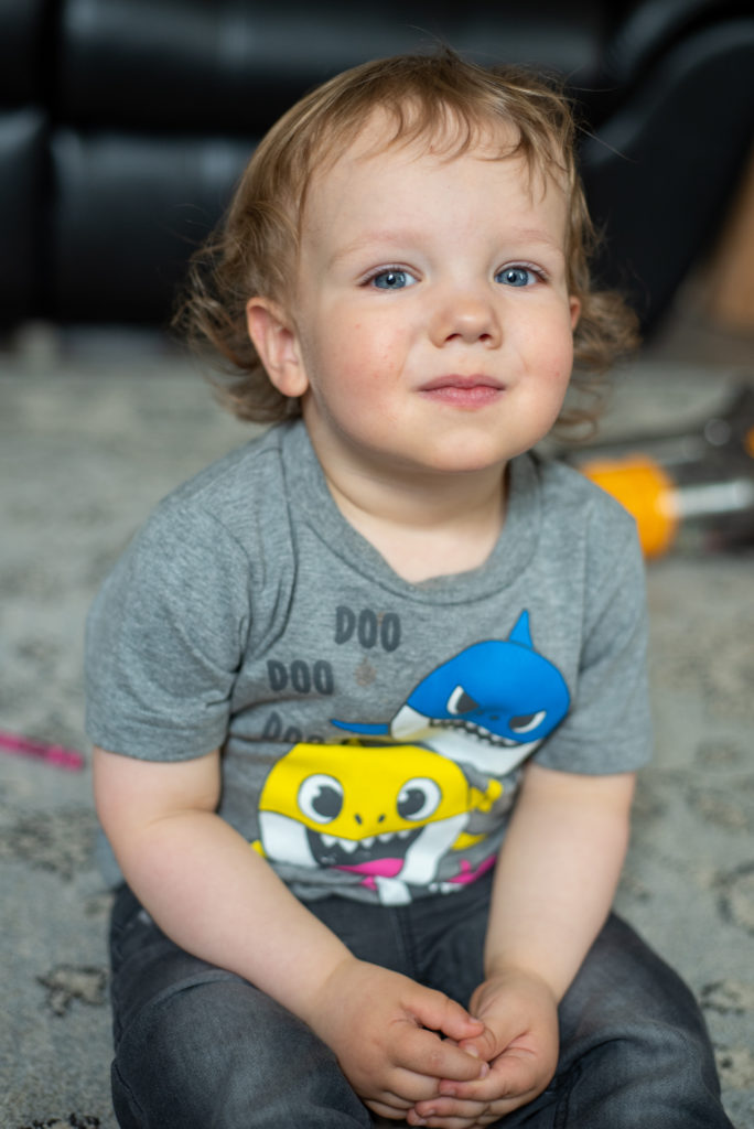 toddler boy sitting smiling