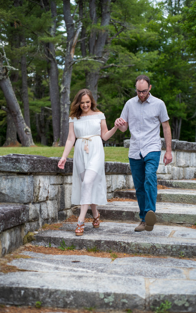 bride and groom holding hands walking down granite stairs at bear brook state park