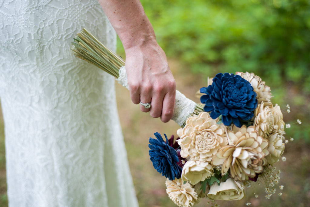 close up of bride's rings and bouquet