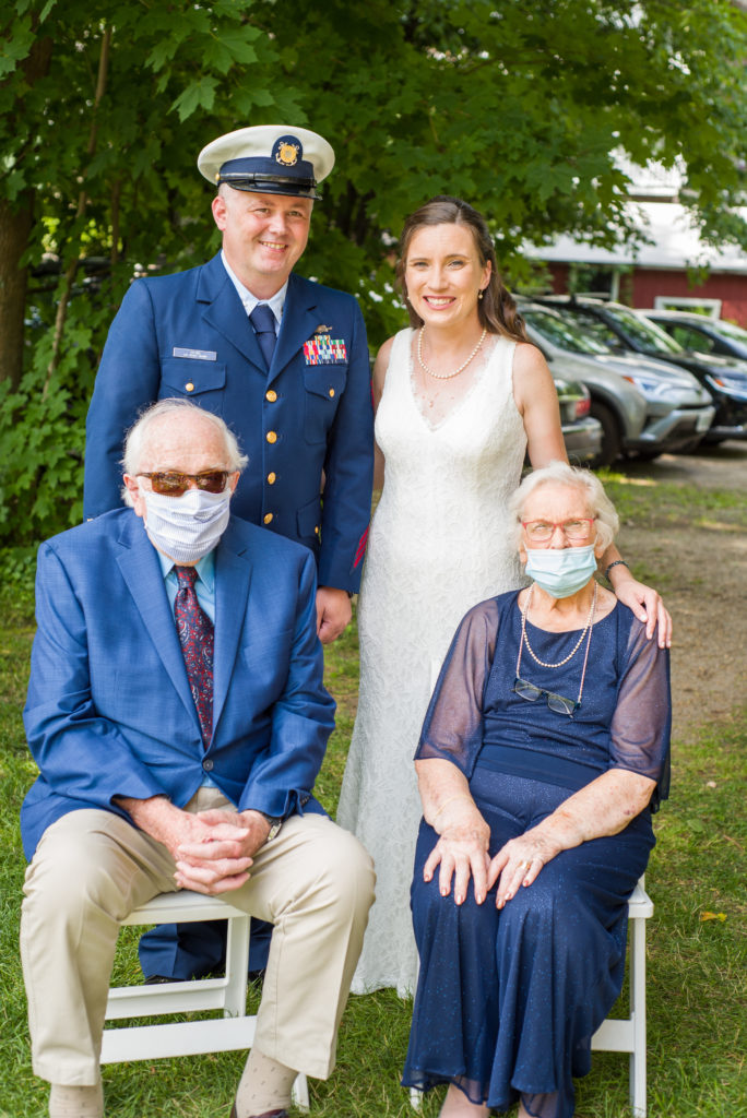 bride and groom with bride's grandparents in masks at Woodstock Inn Brewery