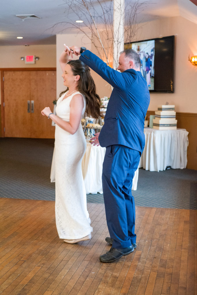 bride and groom during their first dance twirling at the woodstock inn brewery
