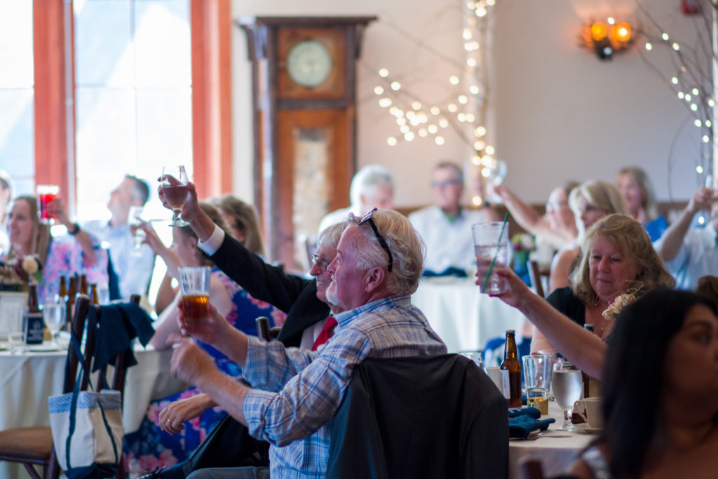 guests lifting their glass for a toast at woodstock inn brewery