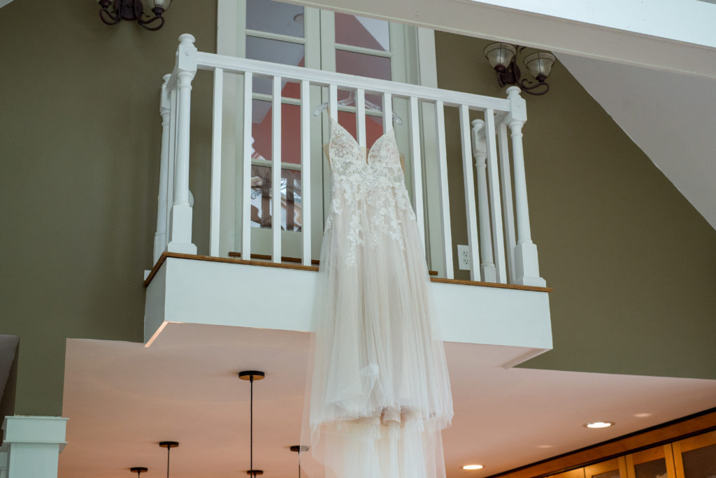 bride's dress hanging from balcony