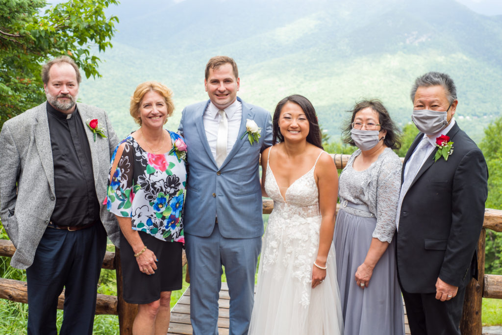 bride and groom with both sets of parents, mountains in the background of mountain top wedding 