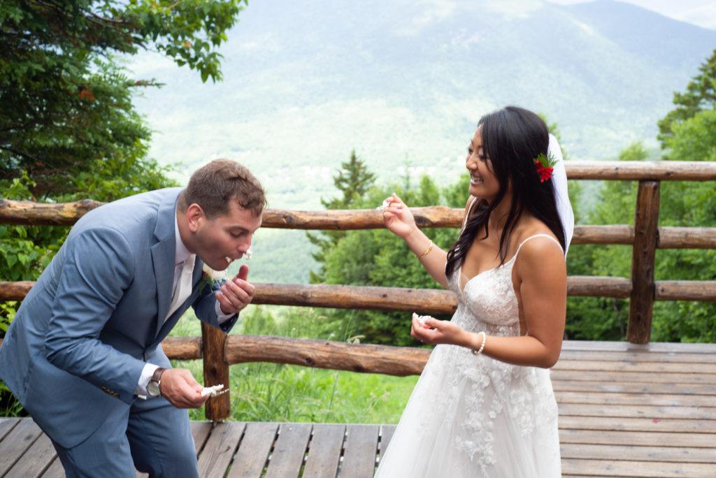groom choking on cake at mountain top wedding 