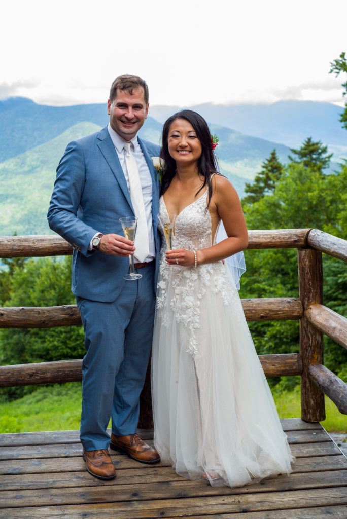 bride and groom with mountains behind them at mountain top wedding 