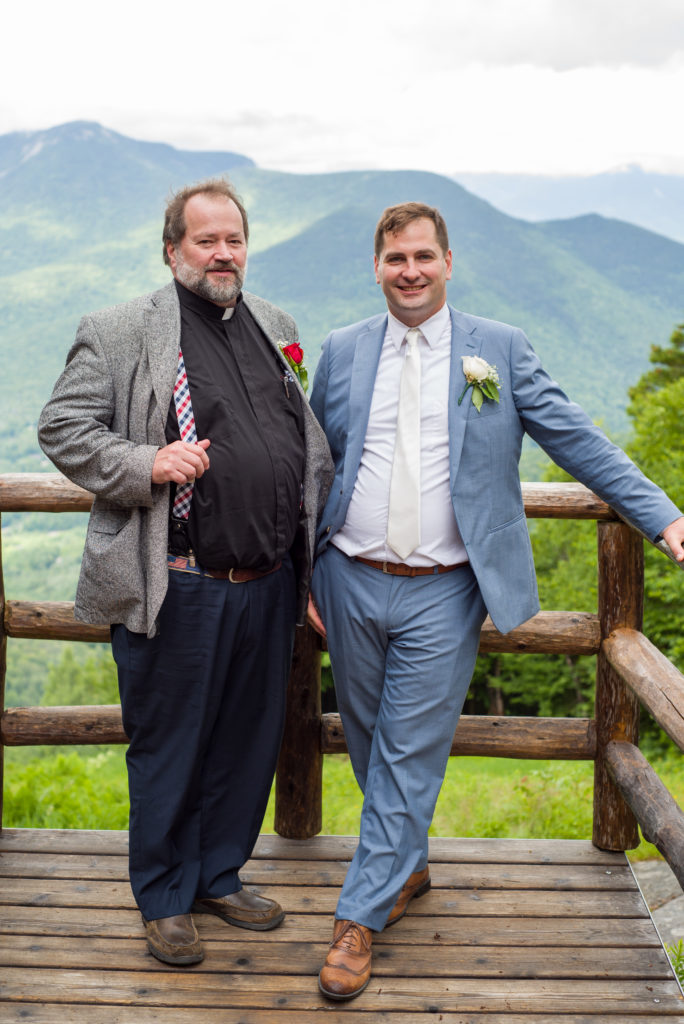 groom with his father at mountain top wedding. dad showing off his suspenders