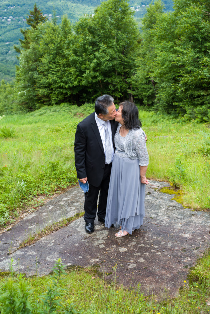 bride's parents kissing at mountain top wedding