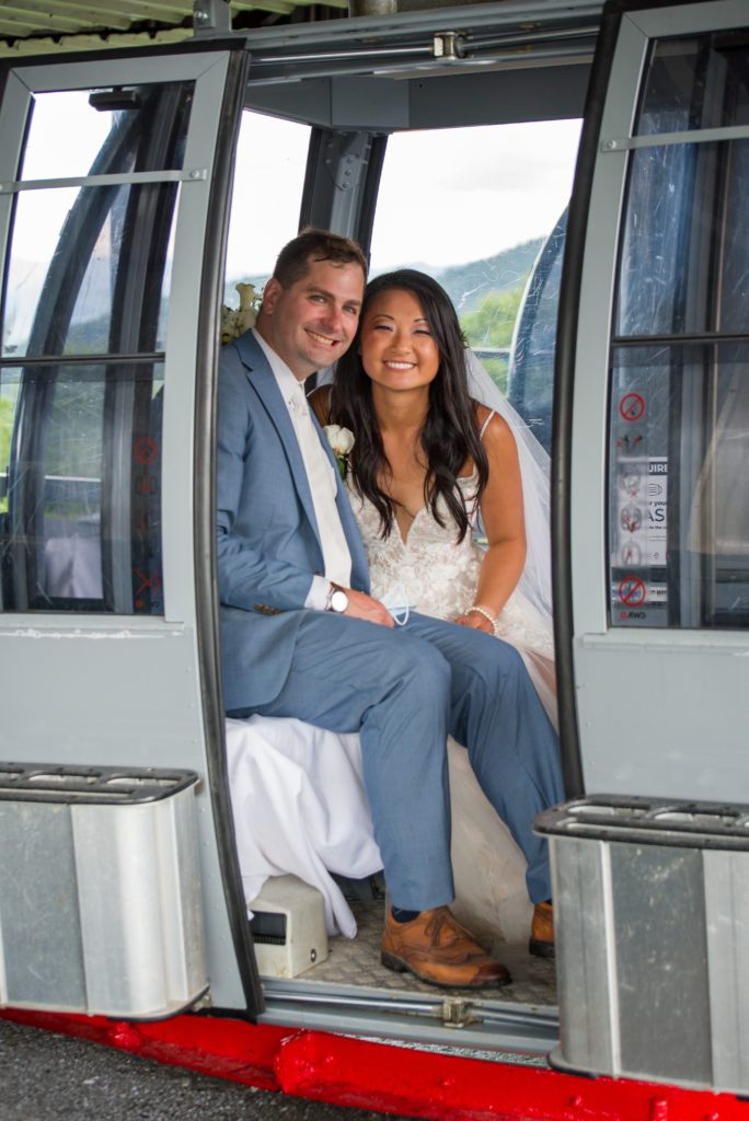 bride and groom in the gondola after mountain top wedding 