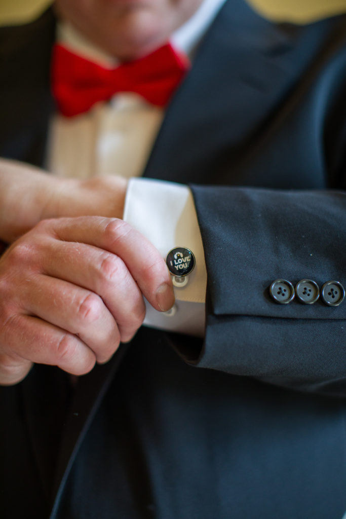 groom showing his cuff link