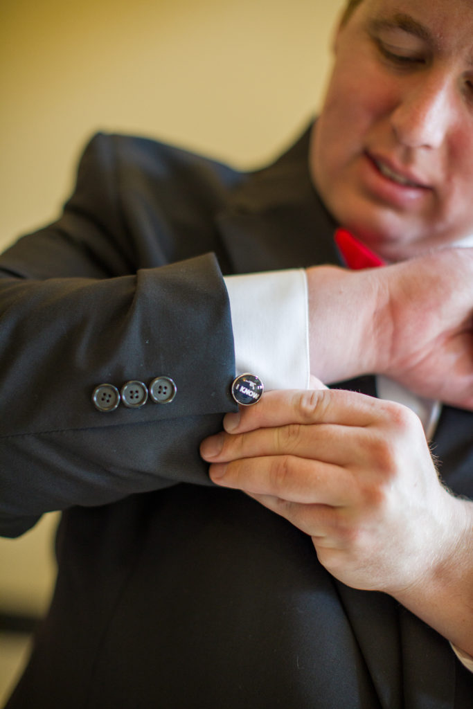 groom showing off his cufflinks