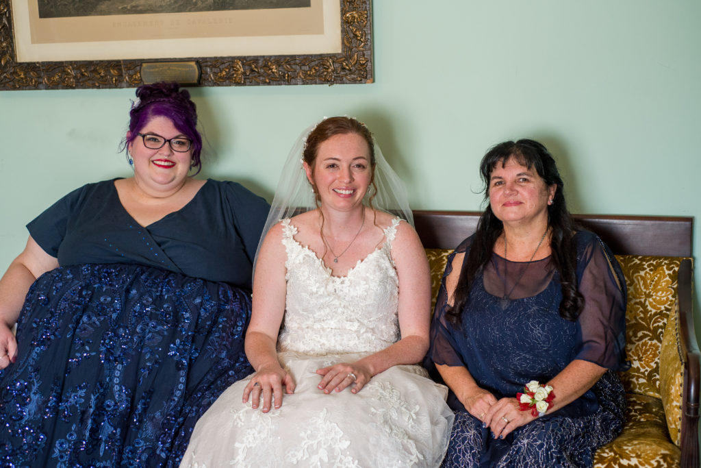 bride, sister, and mom sitting on the couch