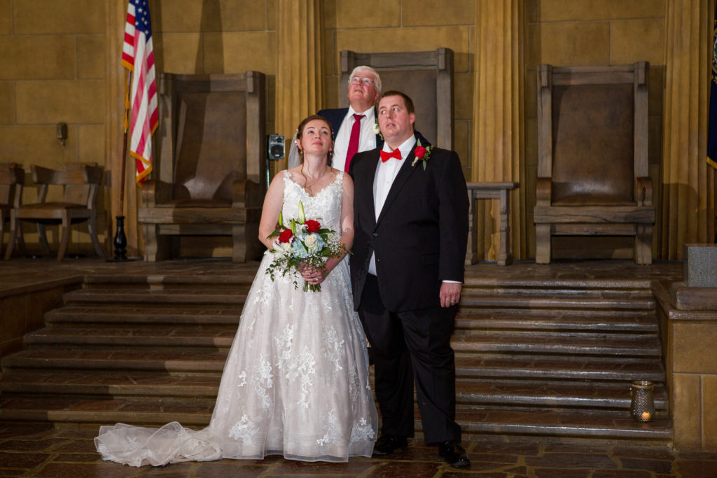 bride and groom watching the light show after their ceremony in masonic temple
