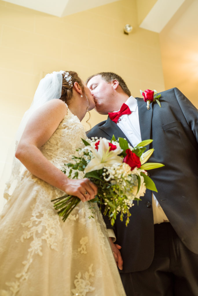 bride and groom kissing after the ceremony at masonic temple