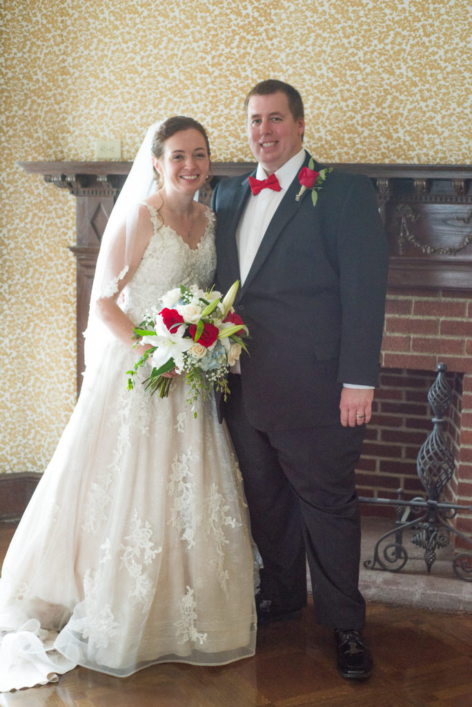 bride and groom posed in front of the fireplace at masonic temple