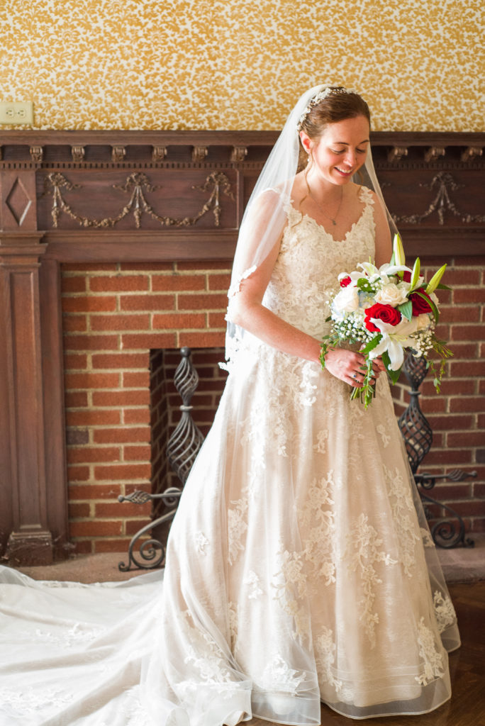 bride glancing at her bouquet at masonic temple