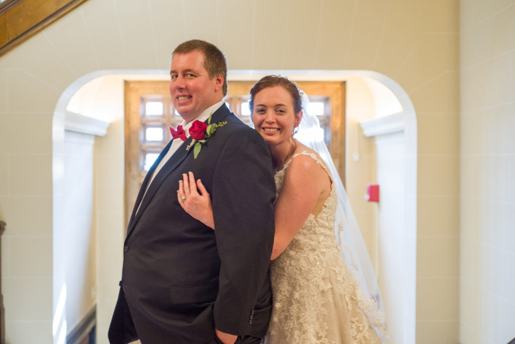 bride hugging groom from behind at masonic temple