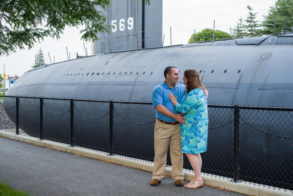 bride and groom smiling at each other in front of the submarine