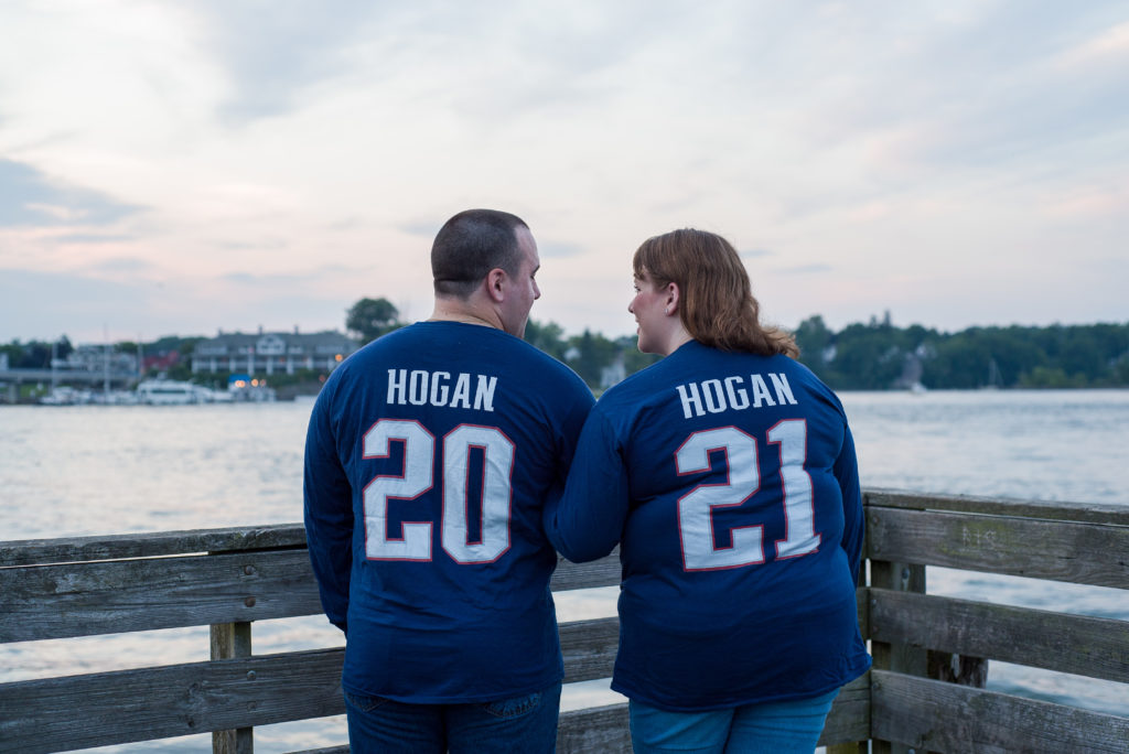 bride and groom in matching patriot's jerseys with 2021 on the back at prescott park 