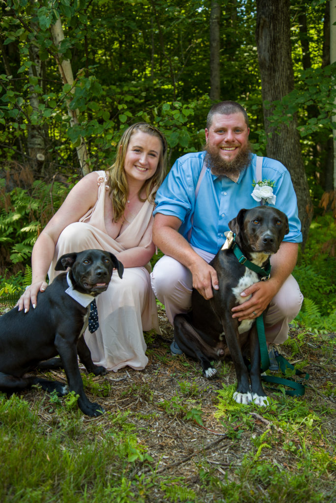 bride and groom with their two dogs after the cermeony