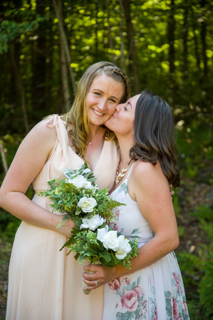 maid of honor kissing bride's cheek after she says I do